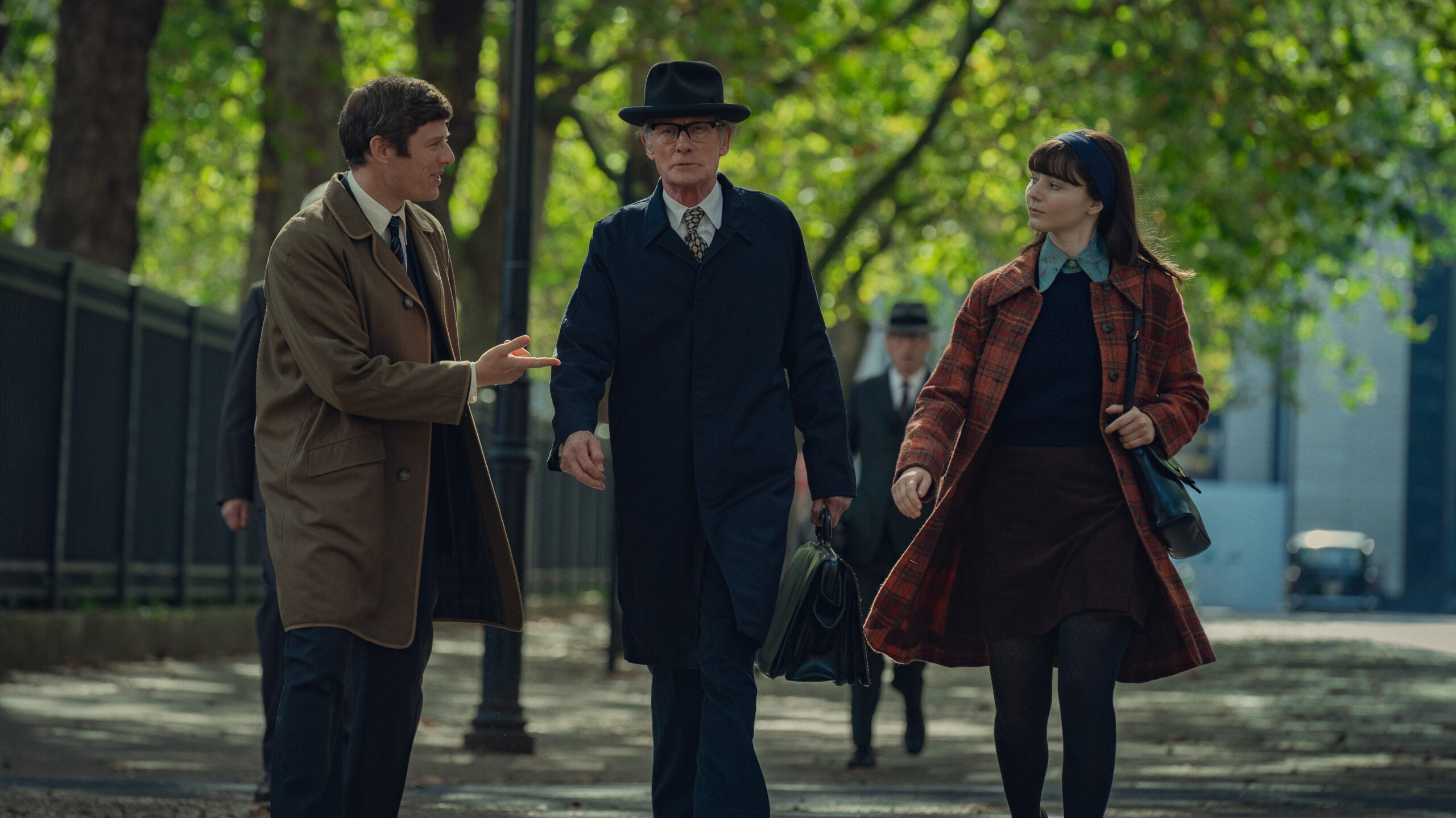 Bill Nighy as Patrick Steptoe, Thomasin McKenzie as Jean Purdy, James Norton as Robert Edwards in film 'Joy' as the character walk through the park together
