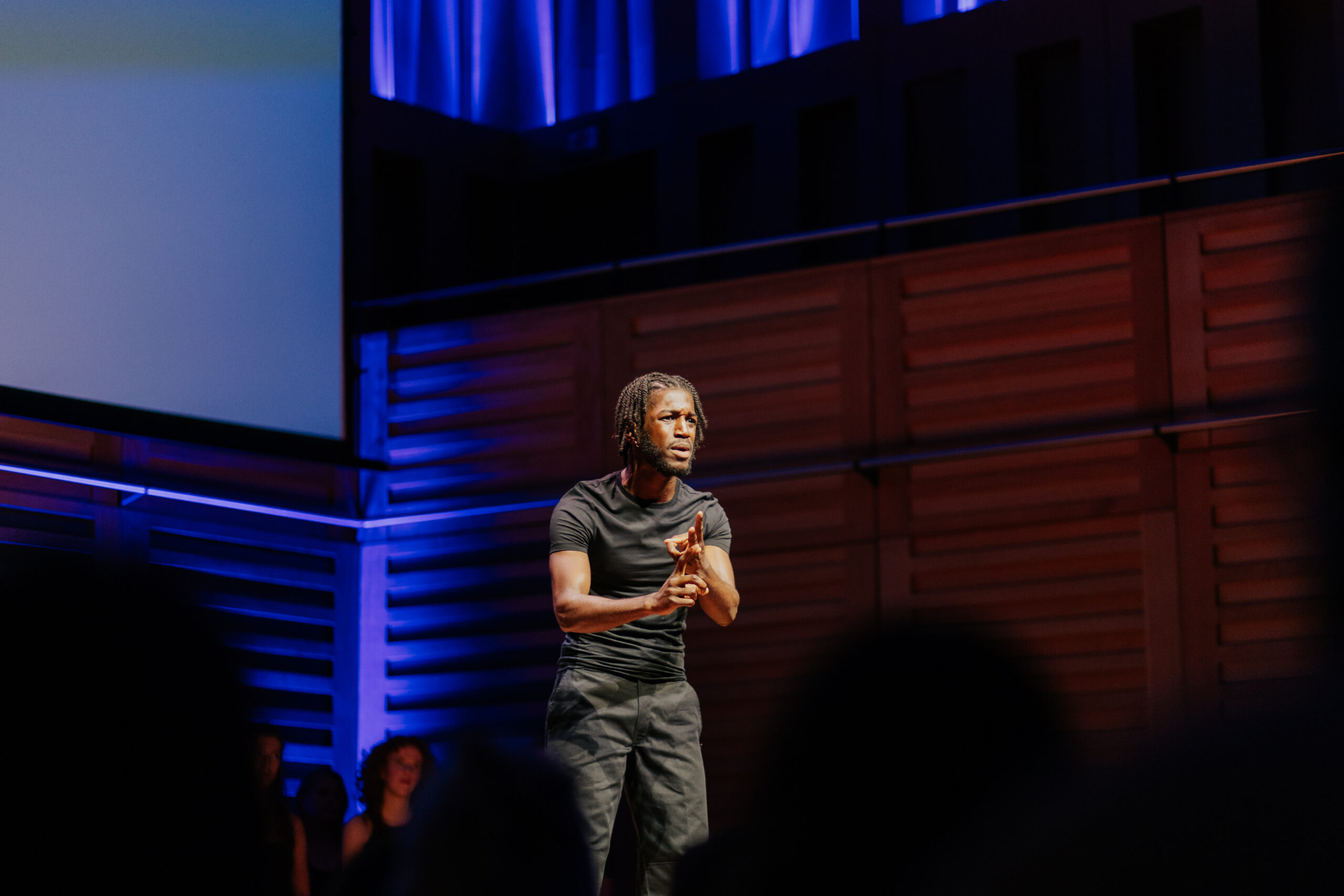 Spotlight Prize 2024 screen prize winner Senam Akpokavi performing his monologue on stage at the showcase