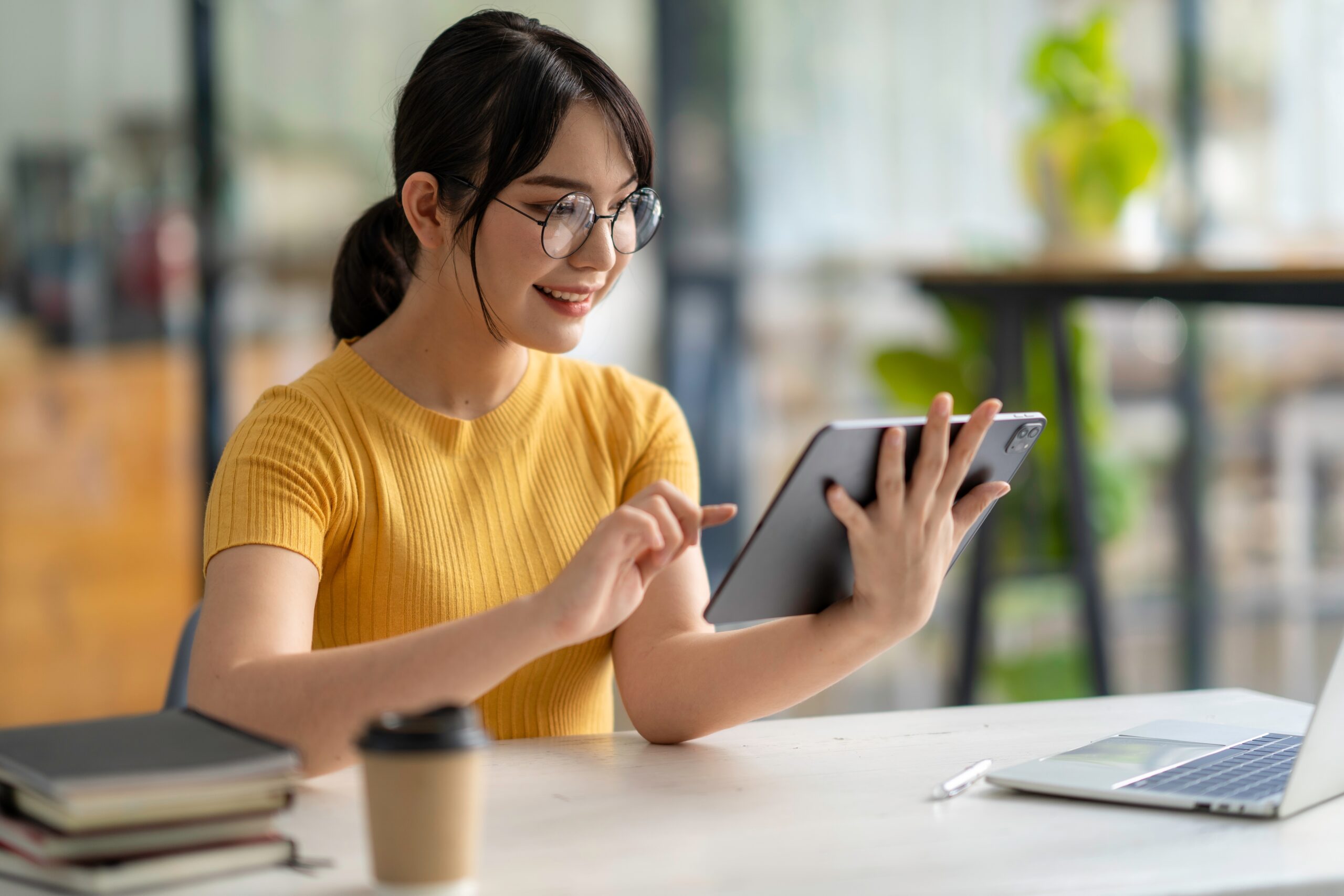 Young woman using a iPad to register as a sole trader