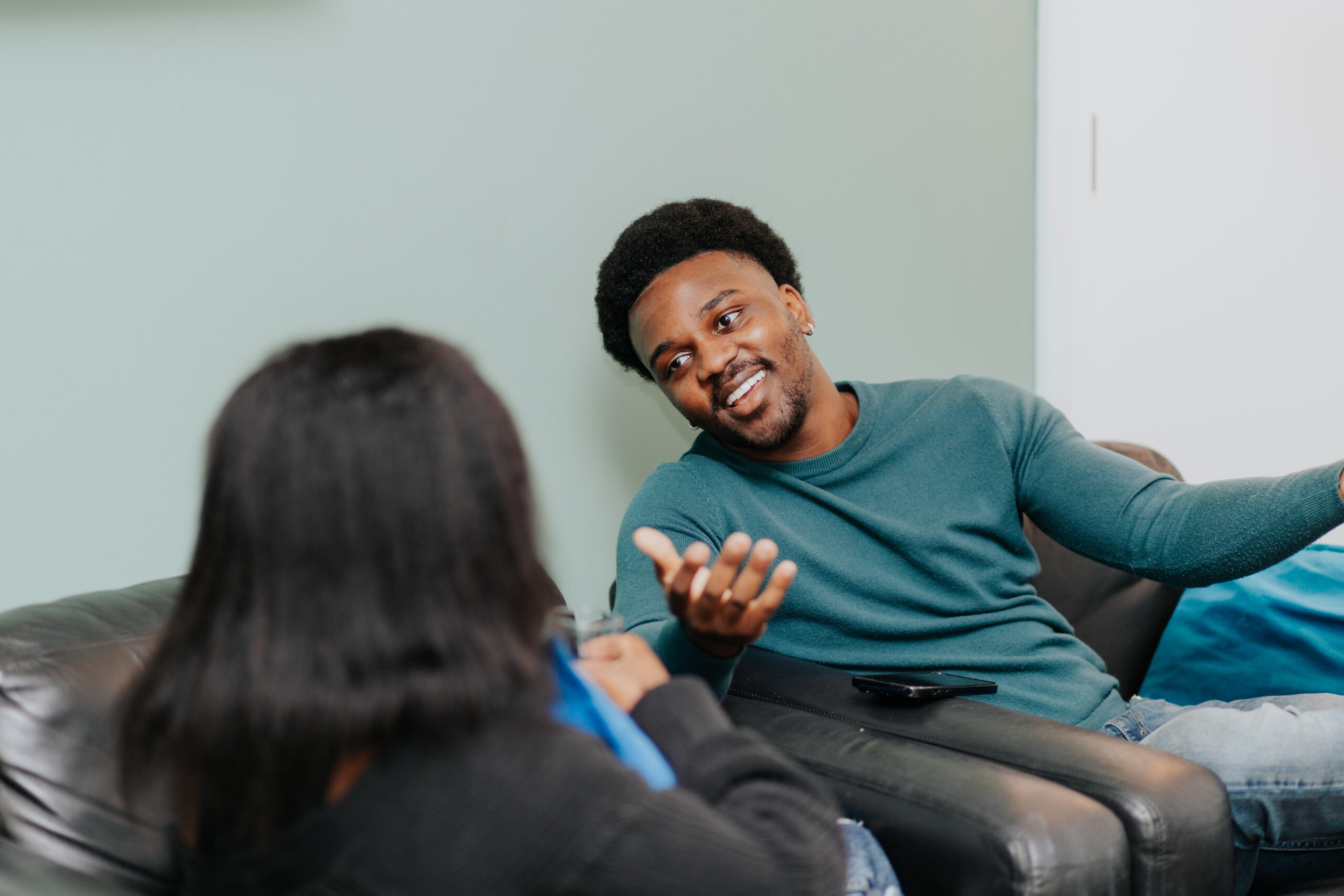 Two young actors sitting in chairs having a discussion