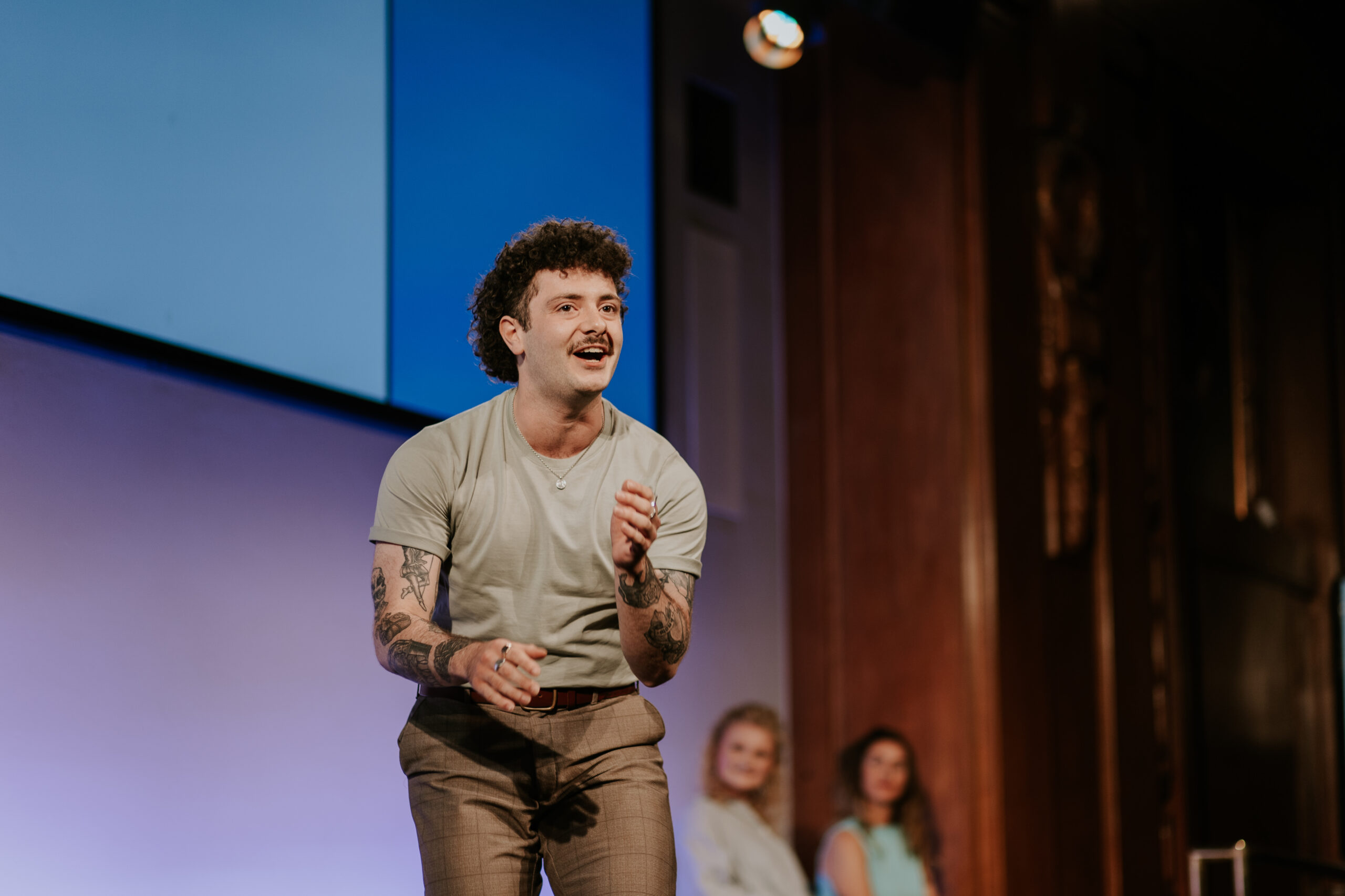 Actor Lucas Albion performing a monologue on-stage at the Spotlight Prize 2023