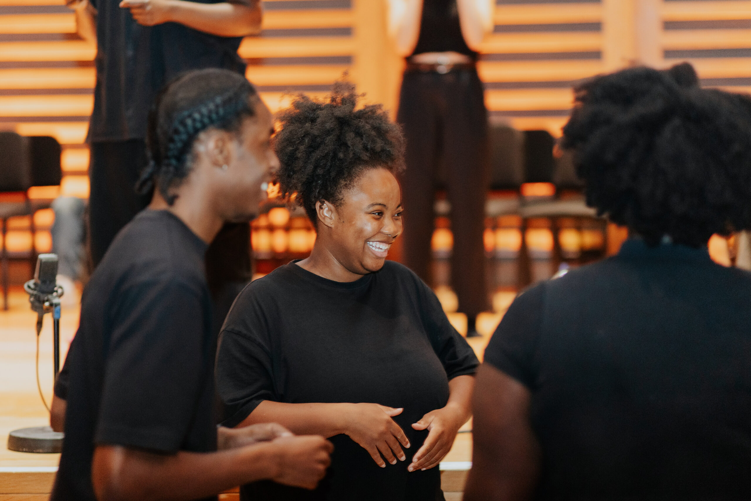 Drama school actors talking together and smiling before a performance