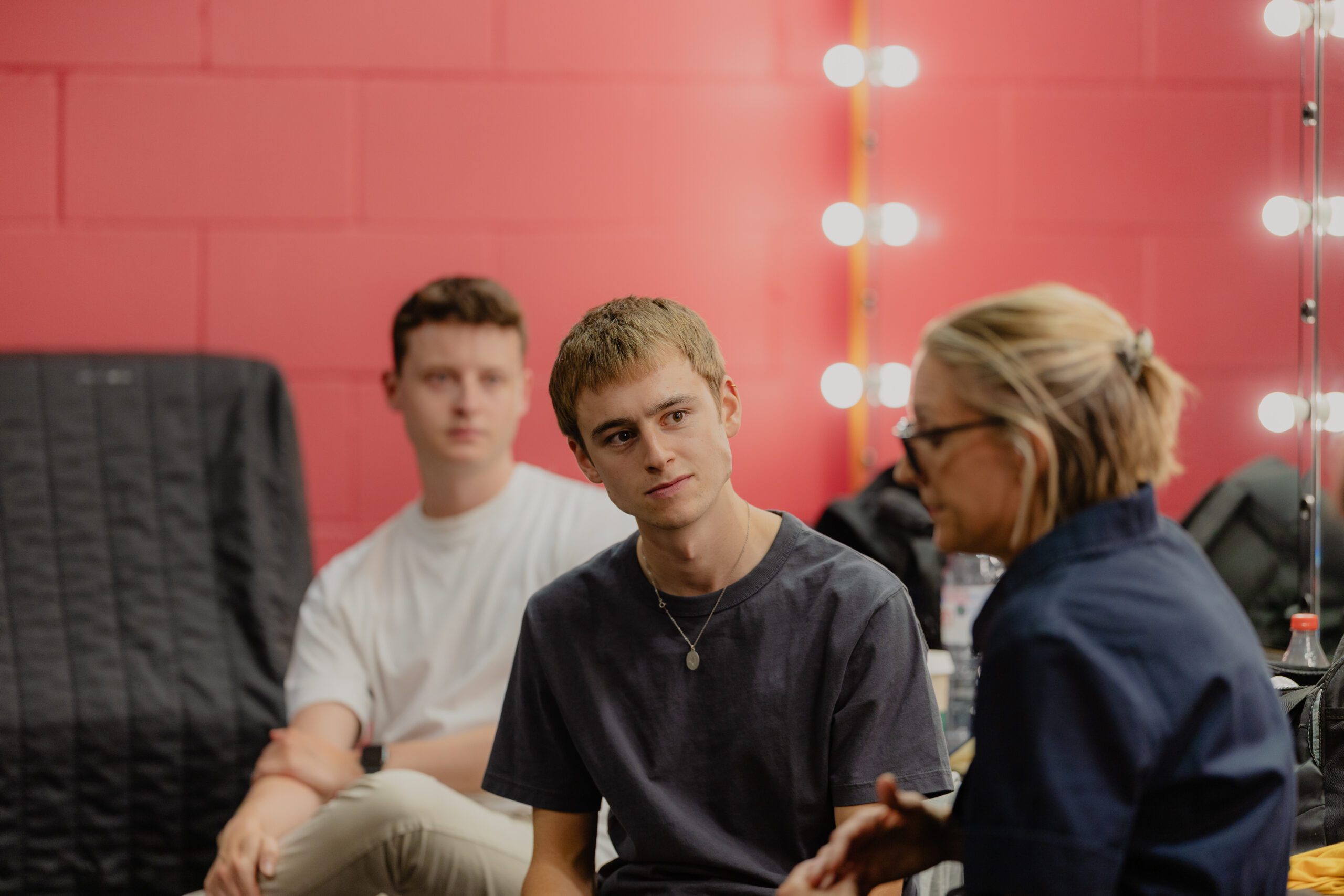 Young theatre actors listening to advice in their dressing room